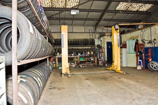 Workshop with tyre racks and vehicle lift